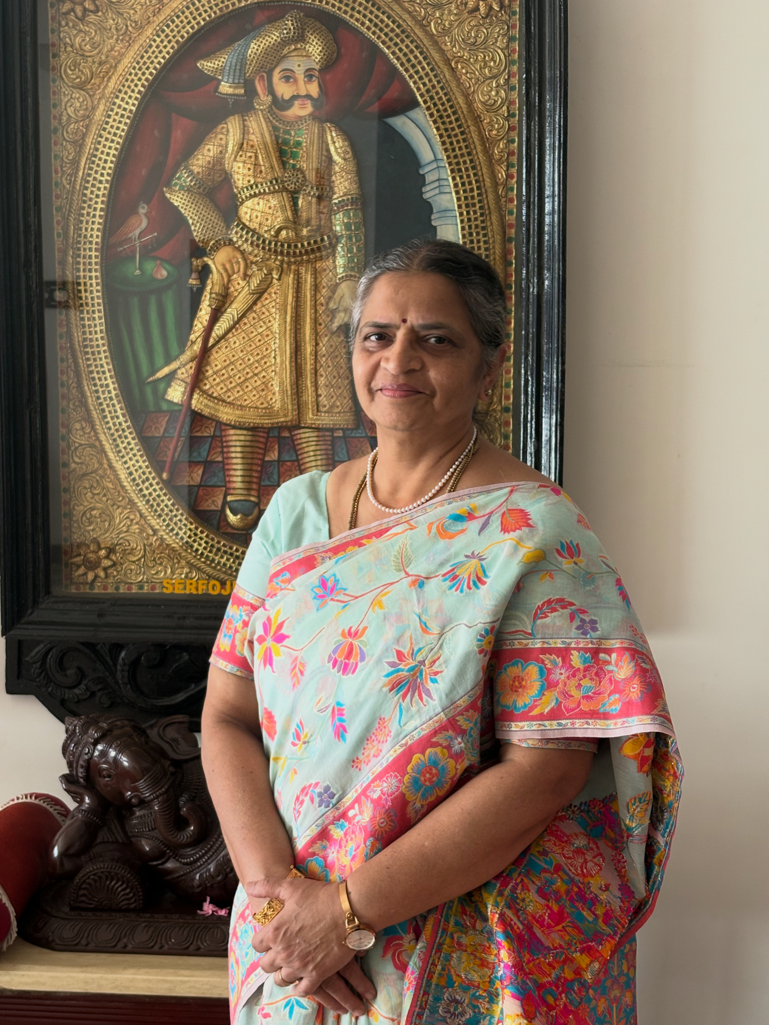 Nannaal’s founder standing beside traditional Indian artwork